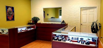 Elegant Rolex watches on display in a well-lit boutique at ATL Time, a reputable repair shop and Rolex reseller.